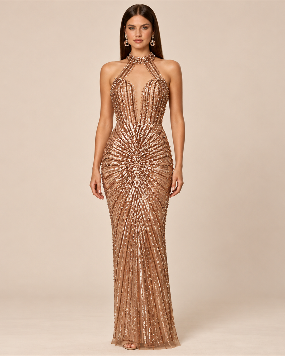 Model wearing the Mercierre Aurelia rose gold beaded halter evening gown with a plunging illusion neckline and sunburst embellishment.